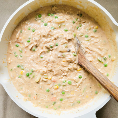 Skillet with creamy chicken pot pie filling
