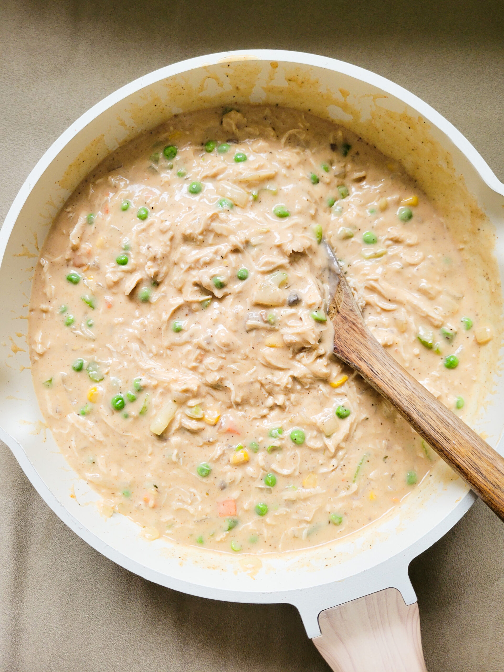 Skillet with creamy chicken pot pie filling